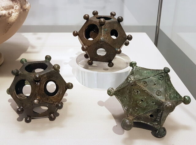  Two ancient Roman bronze dodecahedrons and an icosahedron (3rd c. AD) in the Rheinisches Landesmuseum in Bonn, Germany. The dodecahedrons were excavated in Bonn and Frechen-Bachem; the icosahedron in Arloff. Photo courtesy Kleon3 on Wikipedia, used under a Creative Commons license.