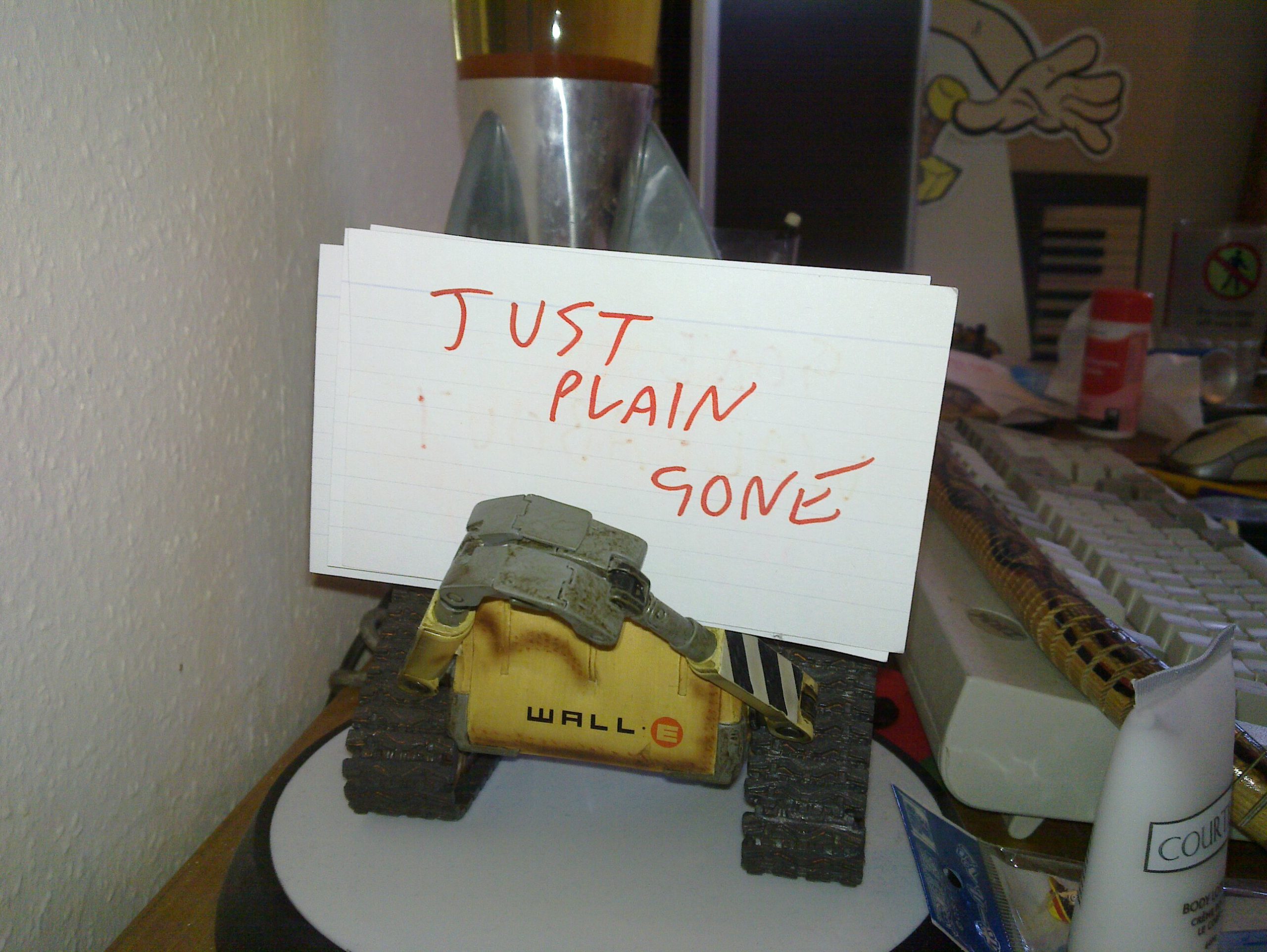 WALL-E holding a "just plain gone" sign.