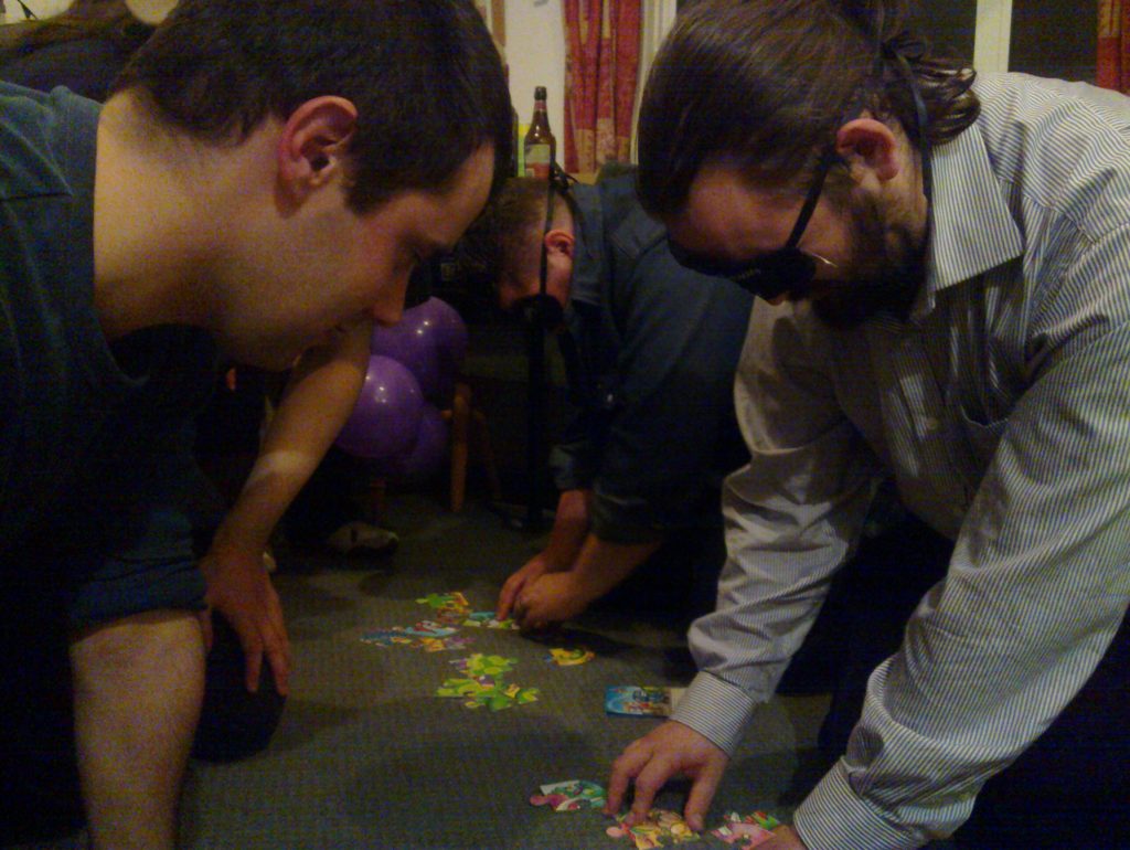 Alec and JTA, blindfolded, attempt to solve jigsaws.