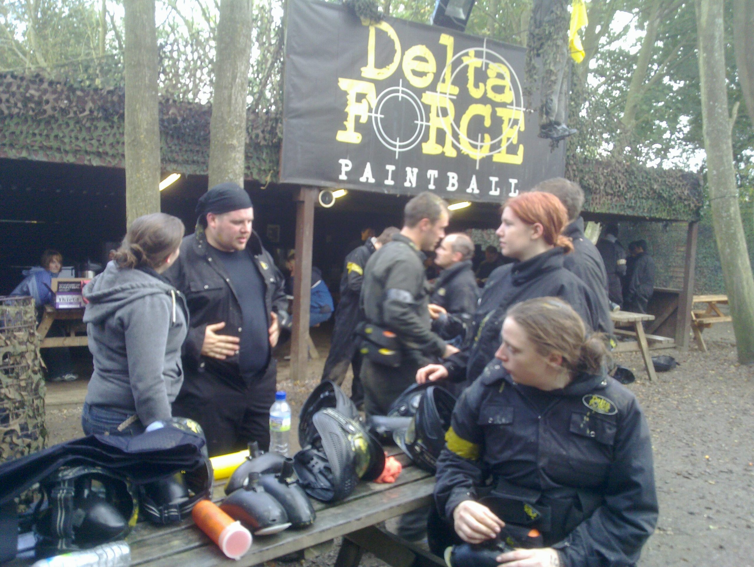 Party people planning paintball play preparations.