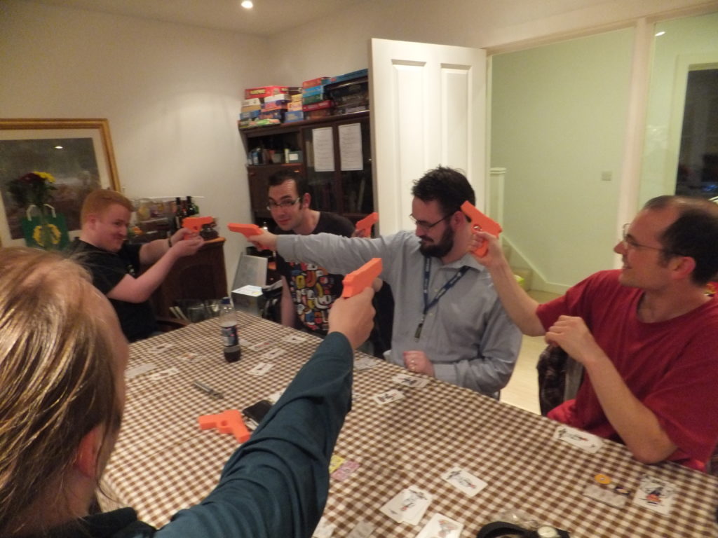 Some early guests play Ca$h 'N' Gun$, a live-action game of gun-toting gangsters.