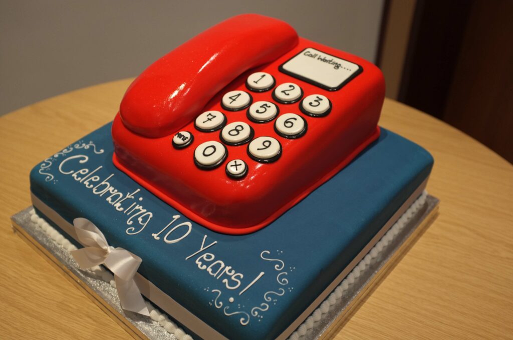 The Three Rings Birthday Cake. It boggles my mind how they've managed to make the icing look so much like plastic, on the phone part.