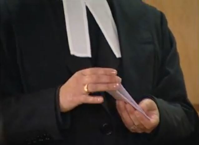 A court clerk shufles a deck of 15 slips of paper.
