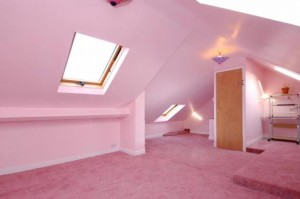 A very pink attic bedroom.