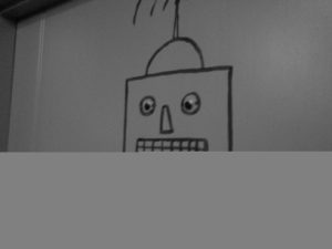 Robot graffiti with googly eyes.