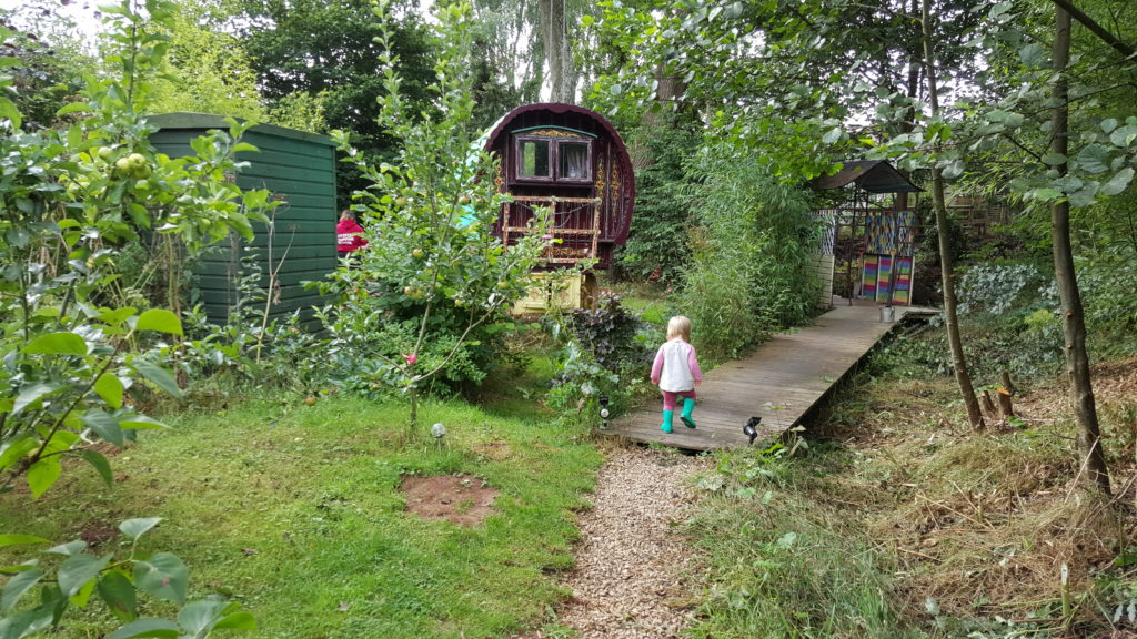 Annabel in wellies stomps through the orchard at Wriggles Brook.