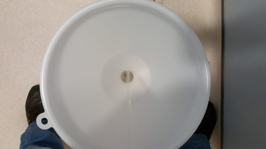 A stream of urine pours down into a funnel.