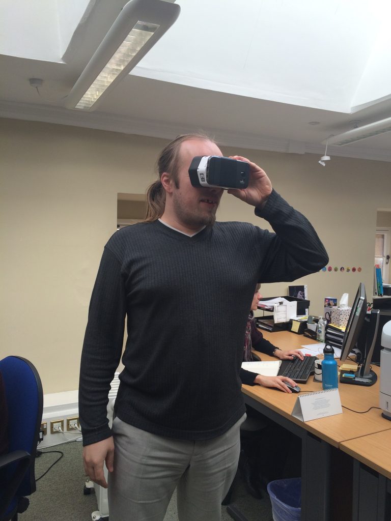 Dan stomps around his office wearing a Google Cardboard.