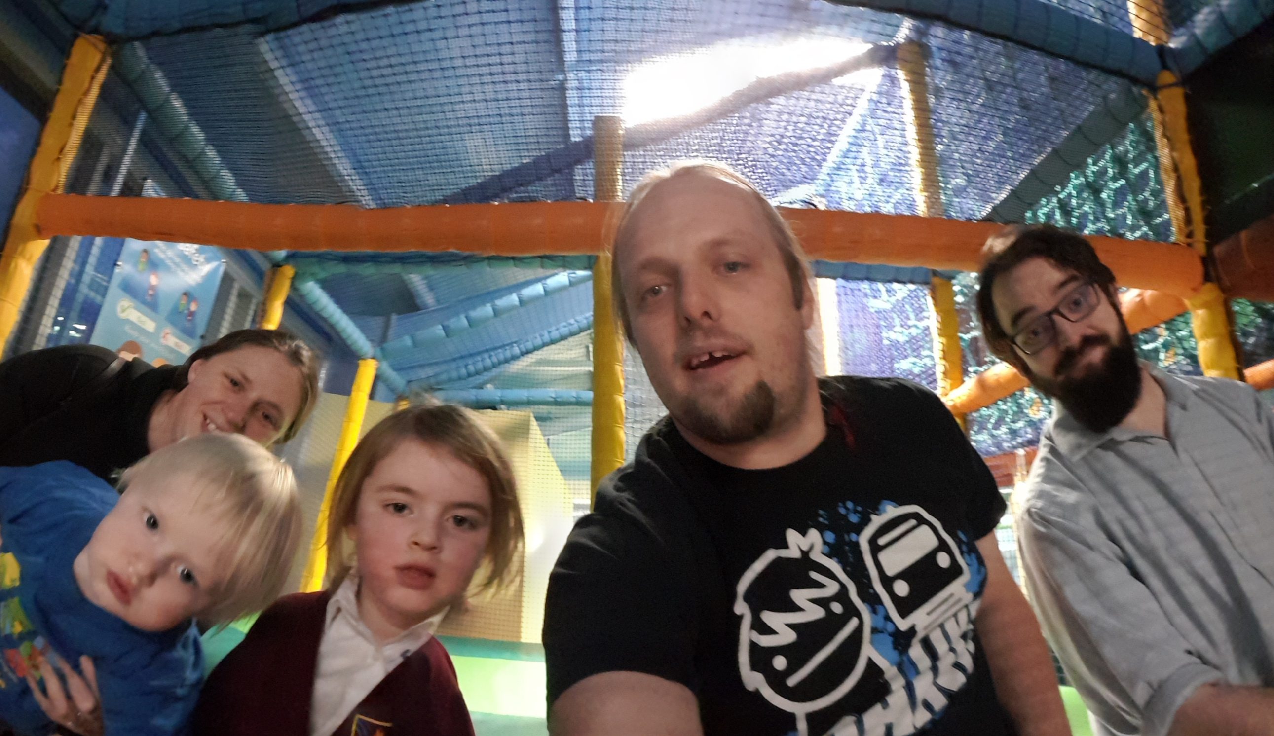 Ruth, Dan, JTA and the kids at the top of the slides at a soft play area.