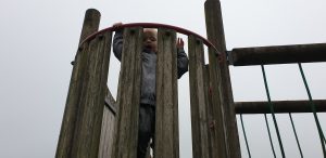 John looks down from the climbing frame.