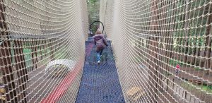 Annabel climbs up to the top nets.