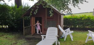 Annabel at the door of her playhouse.