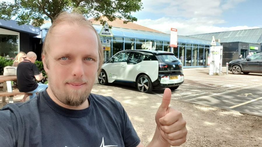 Dan and an eV at a charging point