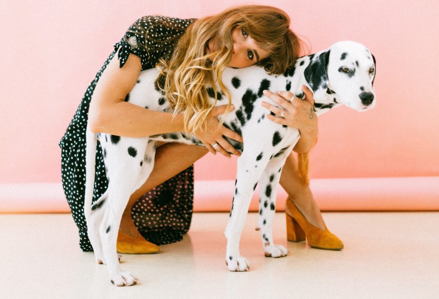 Woman hugging a dalmatian. Photo by Daria Shevtsova from Pexels.