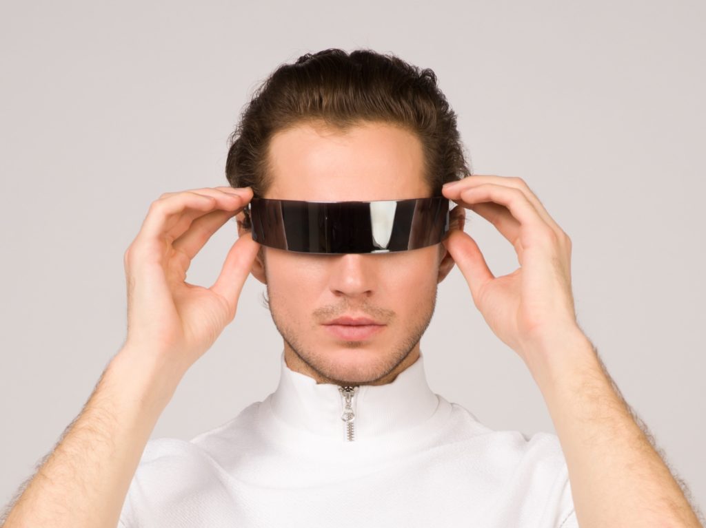 Man in sci-fi jumpsuit and futuristic AR goggles.