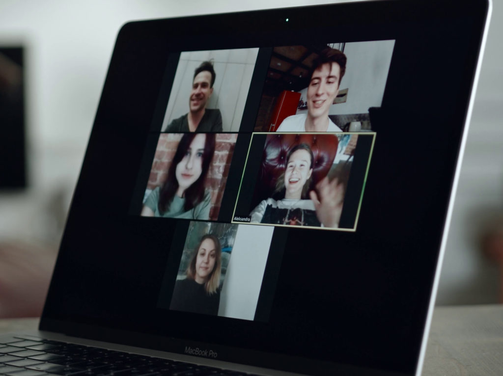 Laptop screen showing five people videoconferencing.