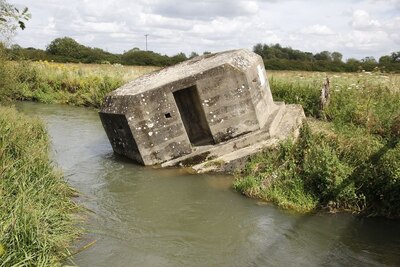 Pillbox sinking into the river