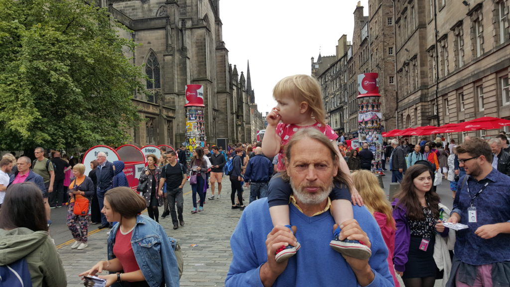 Annabel riding on Tom's shoulders in Edinburgh.