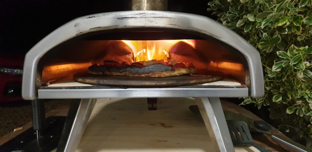 Pizza on fire in oven.