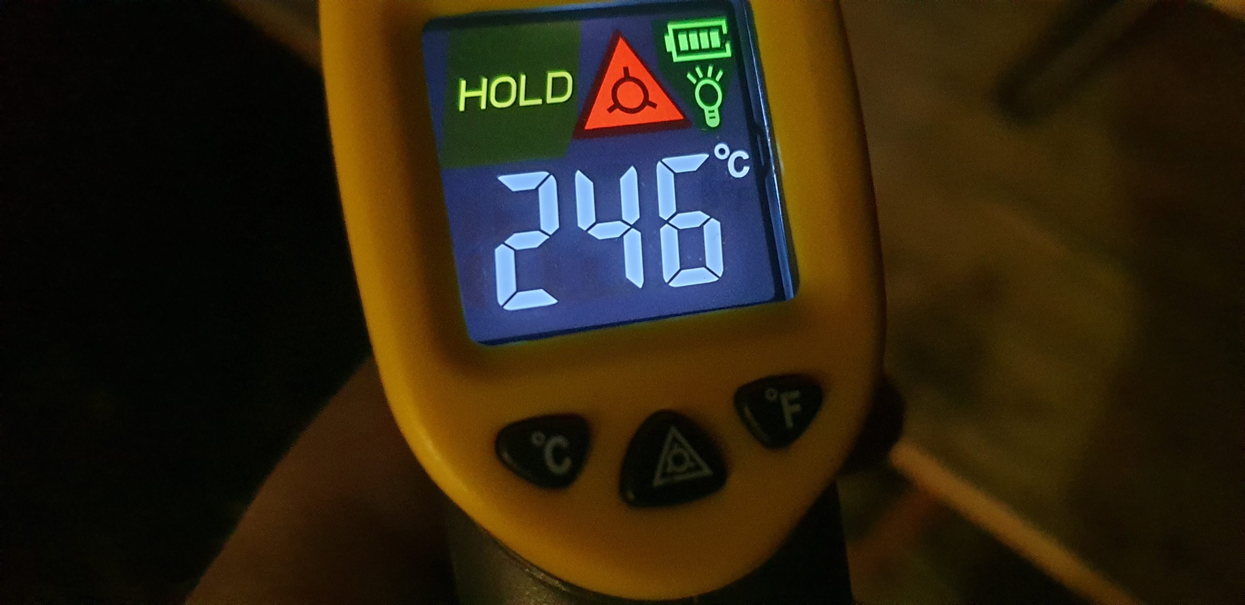 Digital infared thermometer display reading 246ºC.