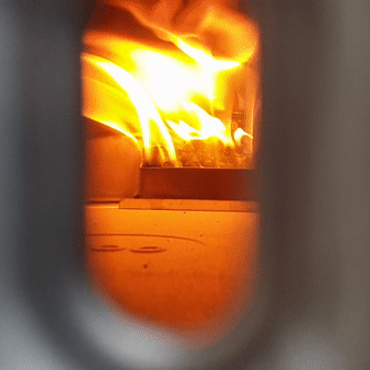 Animated GIF showing the fire blazing as seen through the viewing window on the front of the oven.