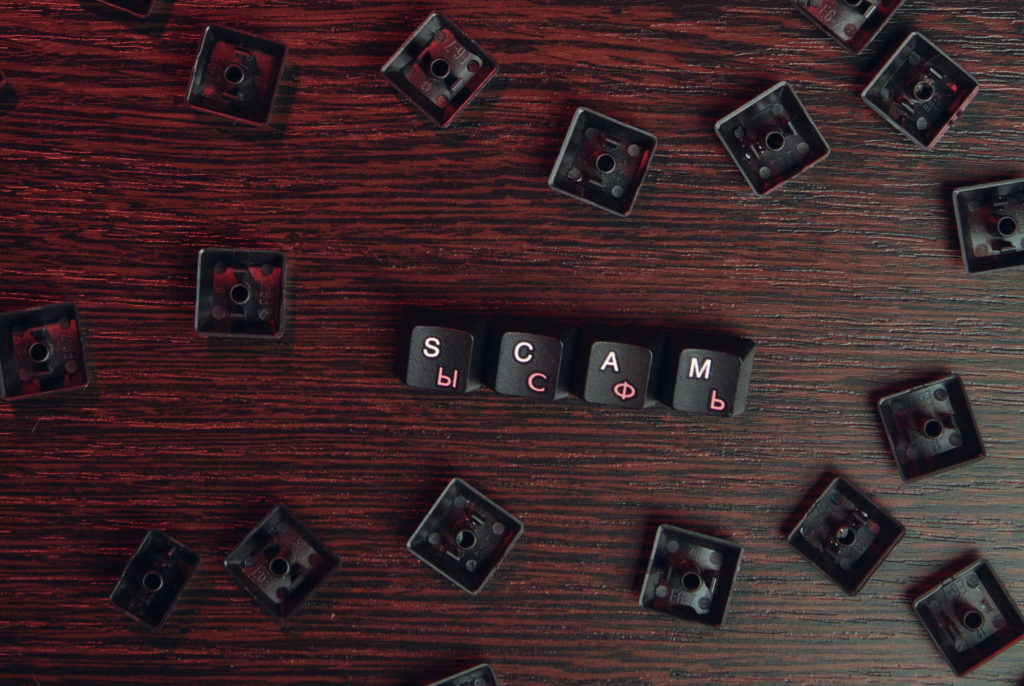 "SCAM" spelled out using keycaps from a cyrillic keyboard. Photo by Mikhail Nilov from Pexels.