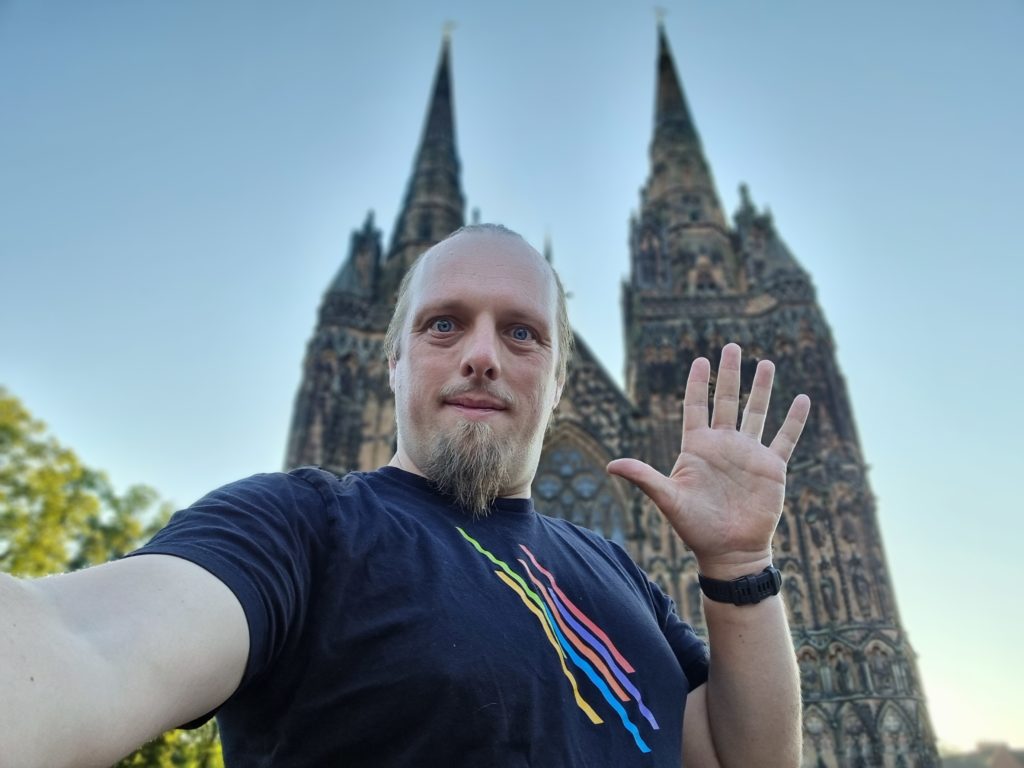 Dan in froint of Lichfield Cathedral, waving