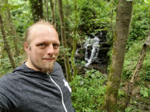 Dan in front of a waterfall.