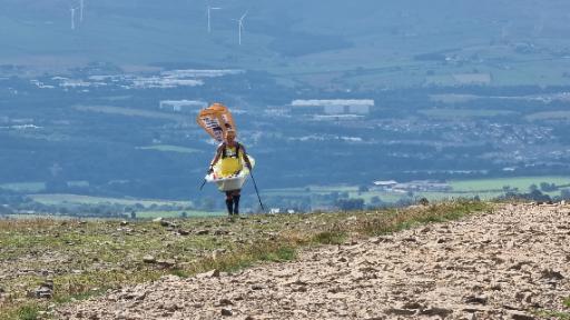 Steve Taylor climbing Pendle Hill carrying a bathtub for at least the second time this morning.