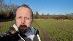 Dan, windswept, in a field