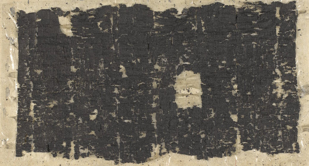 Blackened fragments of an unrolled papyrus.