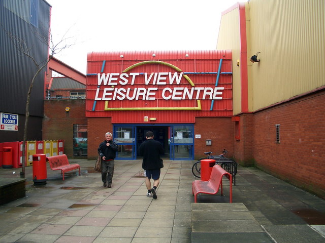 Entryway to "West View Leisure Centre", decorated in a bright, abstract, 80s style.