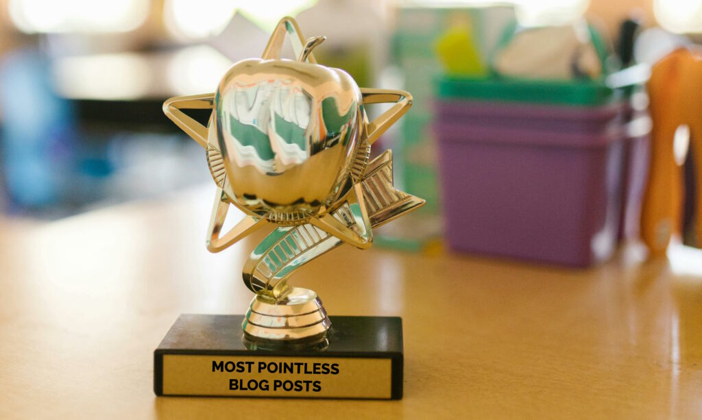 Trophy on a desk with the plaque "most pointless blog posts".
