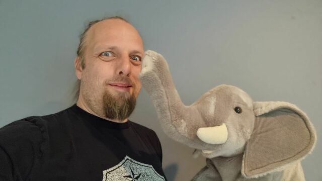 Dan with a stuffed toy (African) elephant.