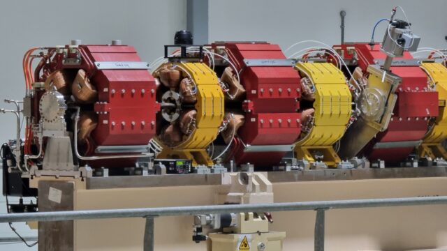 String of large electromagnets used for steering an electron beam.