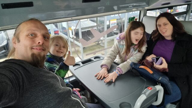 Dan, Ruth, and their children on an airport car park shuttle bus.