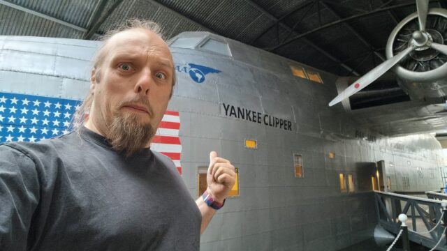 Dan alongside a replica of a flying boat called Yankee Clipper.