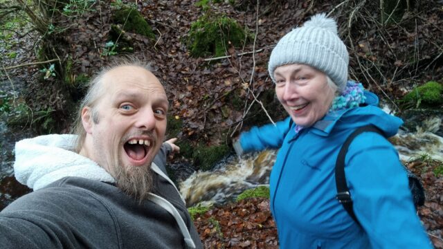 Dan and his mother cheer alongside a raging stream.