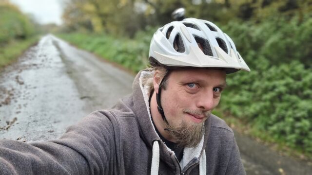 Dan setting off cycling along a country road.