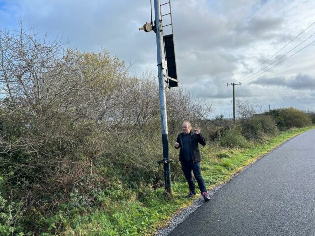 Dan stands by an old fashioned railway signal.