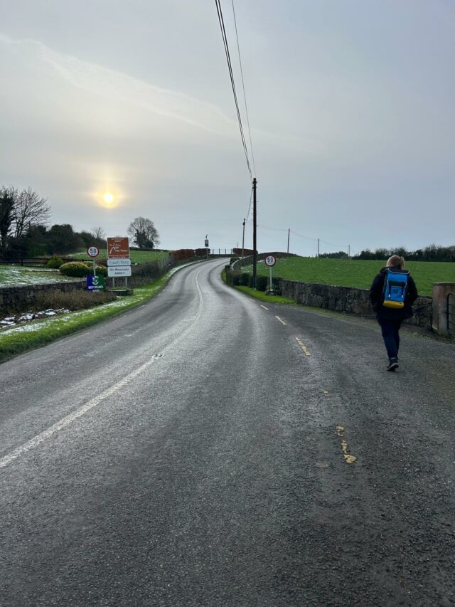 Dan walking down a road.