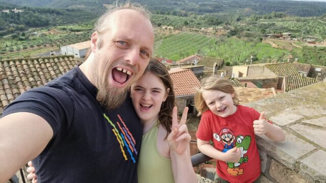 Dan and two kids look excited atop a castle in rural Catalonia.