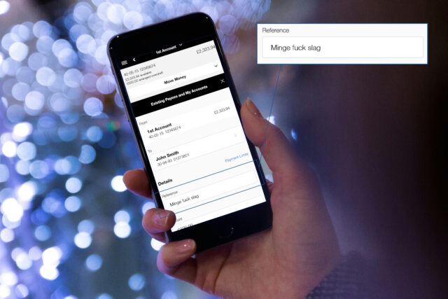 Mobile phone, held in a white person's hand, showing an online banking screenshot: a payment to John Smith is being configured, with the reference set as "Minge fuck slag".