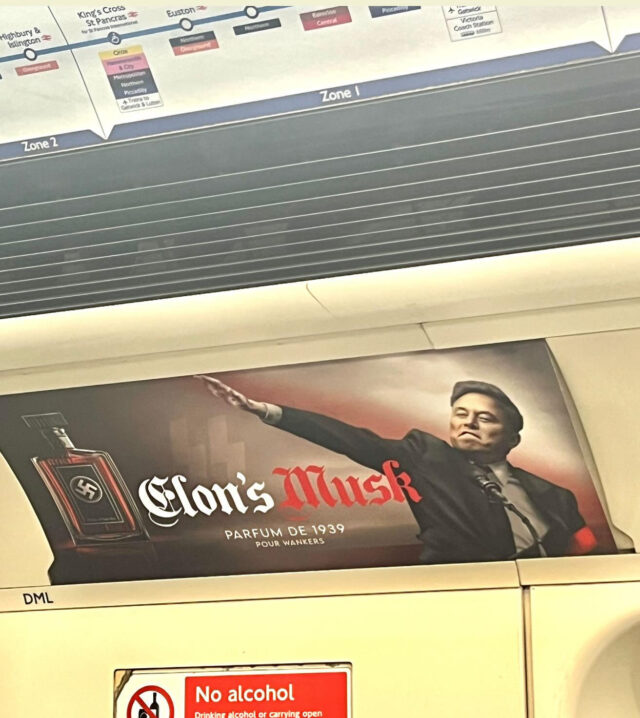 Photo of a parody advertisement on a London Underground train, showing Elon Musk doing a Nazi salute. The fake ad is for 'Elon's Musk', 'parfum de 1939'.