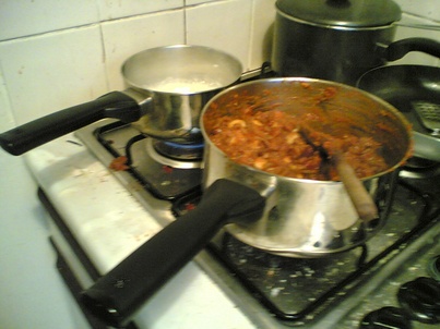 A pan of chilli and a pan of rice