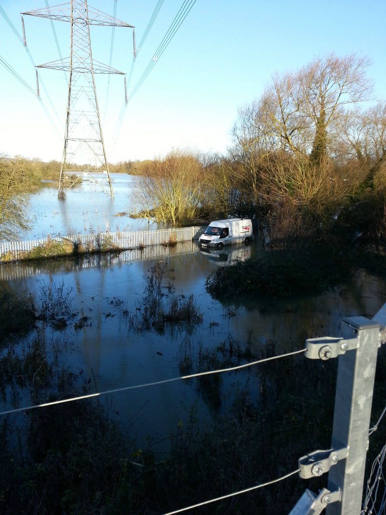 Network Rail engineers sinking into a flooded field