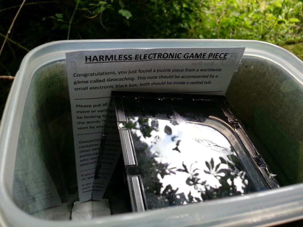 Harmless Electronic Game Piece, written above Box One, in situ