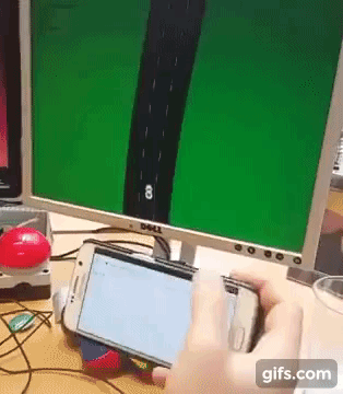 Animated GIF from a video, showing a player using their mobile phone to steer a car on a desktop computer screen, all using the web browsers on both devices.