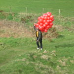 Paul approaches carrying the balloons