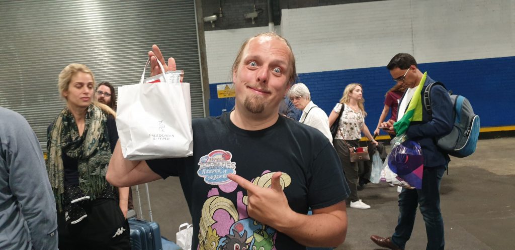 Dan with a bag of snacks and shit from the train crew.